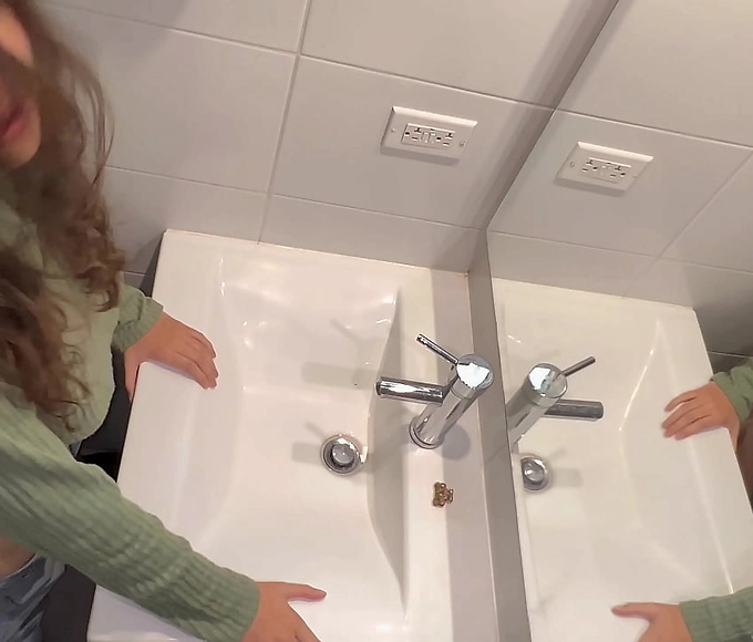 Sultry MILF Enchantress Flashes Alluring Assets in Public Bathroom at Family Gathering